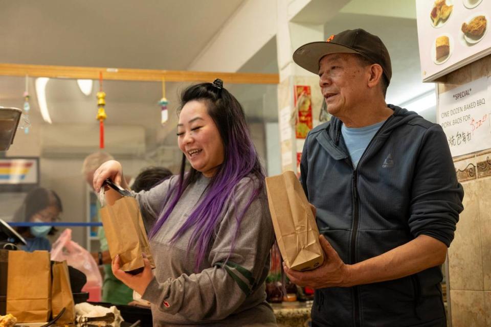 Anna Lee and her father Yao Li serve dim sum at Lam Kwong Deli & Market on March 20.