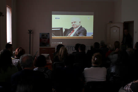 People watch a television broadcast of the court proceedings of former Bosnian Serb general Ratko Mladic in his hometown of Kalinovik, Bosnia and Herzegovina, November 22, 2017. REUTERS/Denis Kapetanovic