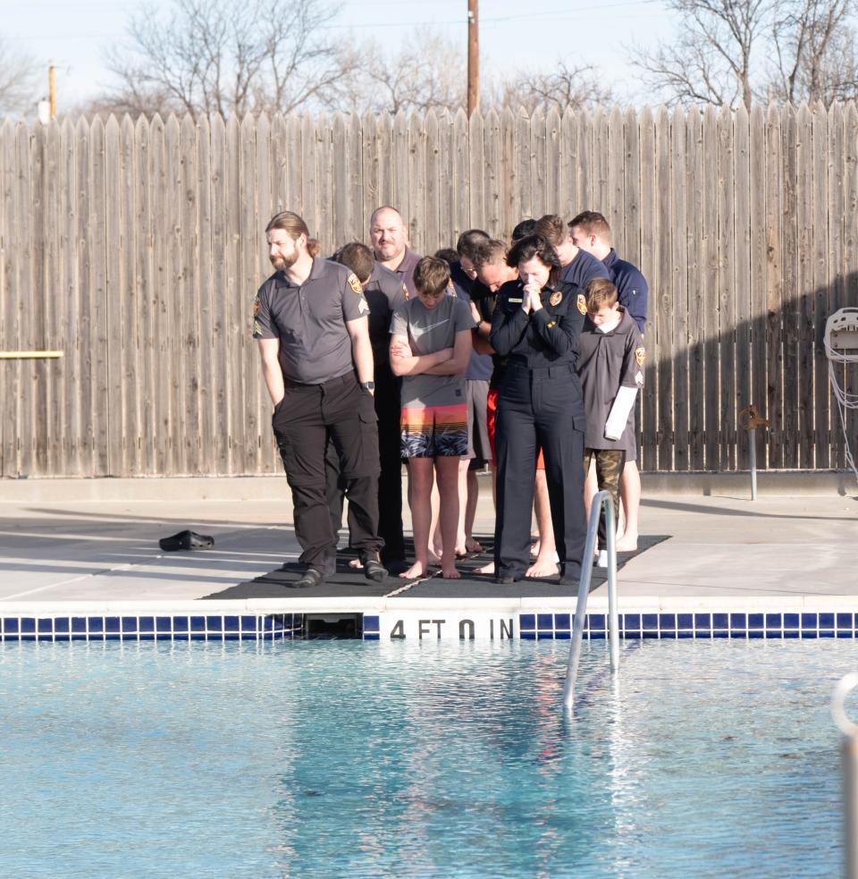 Members of the Amarillo Police Department spend a moment in prayer before the Polar Plunge Saturday morning at the Amarillo Town Club.