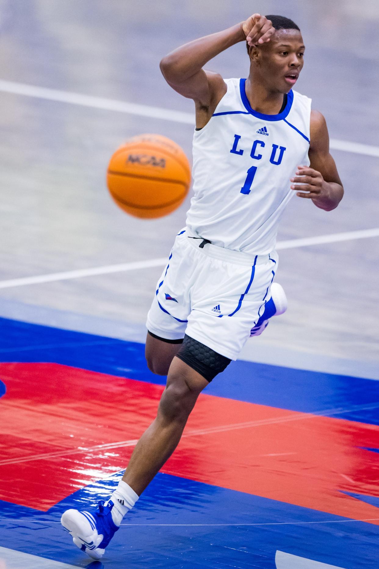 Lubbock Christian University guard Najeeb Muhammad (1) passes the ball during Thursday's game against St. Edward's at the Rip Griffin Center. LCU won 82-57.