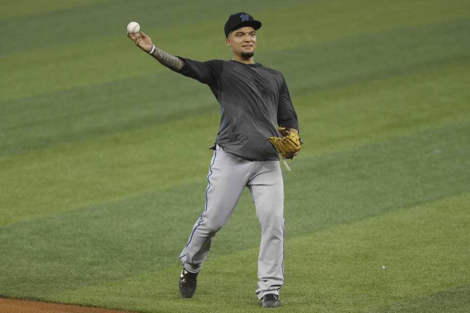 Isan Diaz throws a baseball.