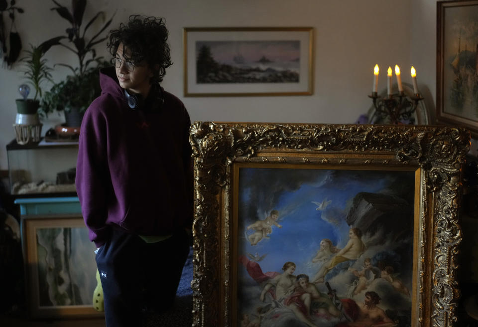 Fabian Swain stands in the entryway in his Germantown, Md., home, Monday, Nov. 14, 2022. Fabian and his mother, Carey Johnson, have recovered from COVID. (AP Photo/Carolyn Kaster)