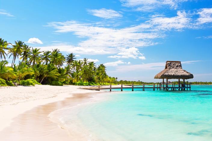 Panorama of beautiful gazebo on the tropical white sandy beach in Punta Cana, Dominican Republic.