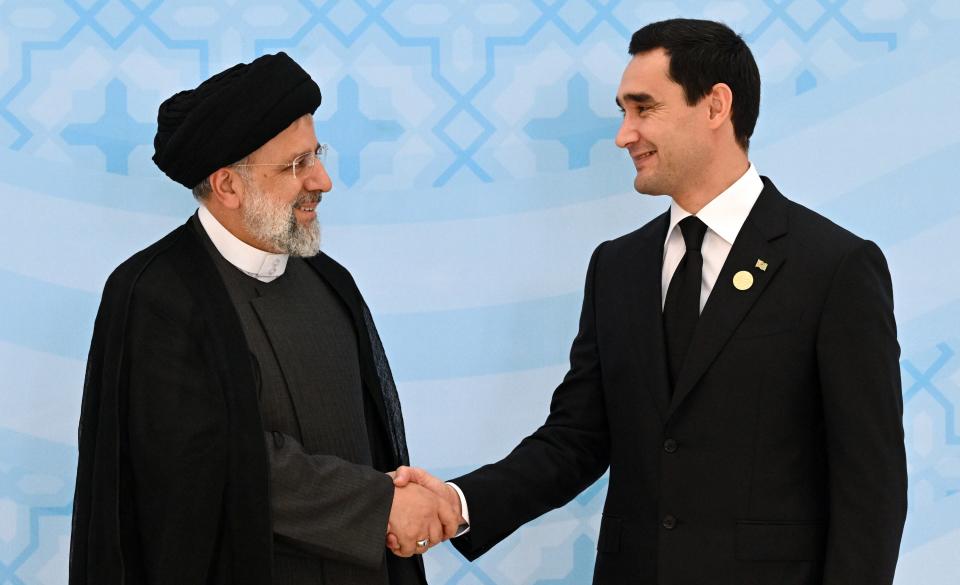 Iran's President Ebrahim Raisi, left, and Turkmenistan's President Serdar Berdymukhamedov greet each other on the sideline of the summit of Caspian Sea littoral states in Ashgabat, Turkmenistan, Wednesday, June 29, 2022. (Grigory Sysoyev, Sputnik, Kremlin Pool Photo via AP)