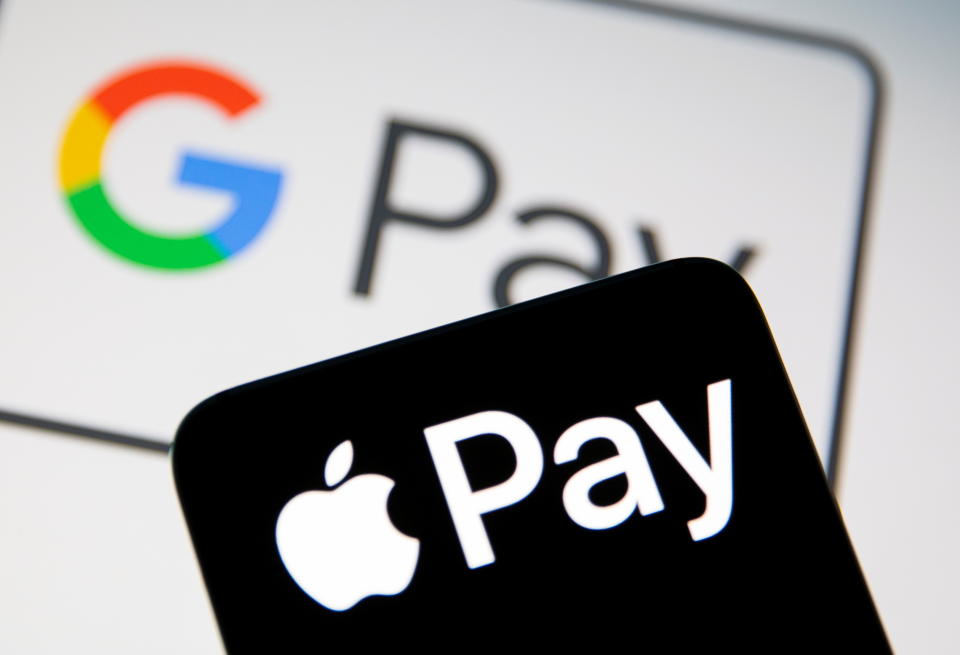 A smartphone with the Apple Pay logo is placed on a displayed Google Pay logo in this illustration taken on July 14, 2021. REUTERS/Dado Ruvic/Illustration