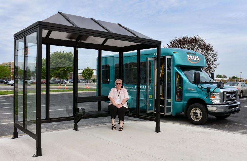 TRIPS Transportation Specialist Lori Beers sits in the new TRIPS bus shelter on North Street. A bus shelter was also constructed in front of the Fremont Walmart.