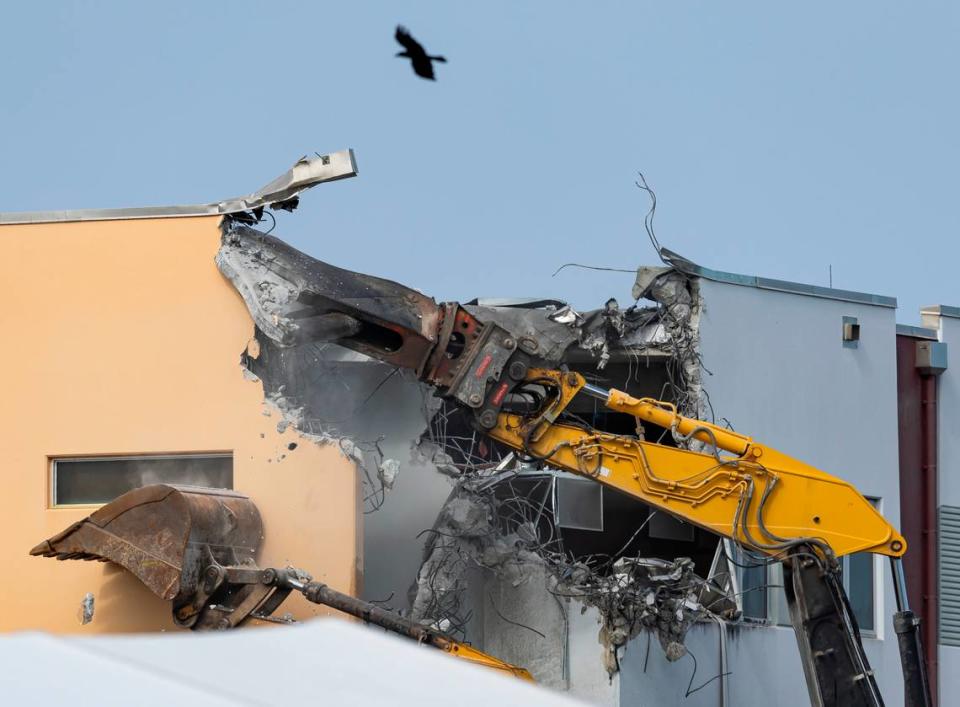 Crews use heavy equipment to tear down the 1200 building of Marjory Stoneman Douglas High School on Friday, June 14, 2024, in Parkland, Fla. On February 14, 2018, a gunmen entered the school and killed 17 people.
