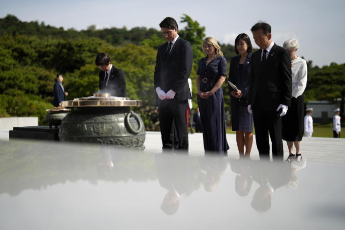 Canadian Prime Minister Justin Trudeau, center, pays a silent tribute at the National Cemetery in Seoul, South Korea, Wednesday, May 17, 2023. (AP Photo/Lee Jin-man, Pool)