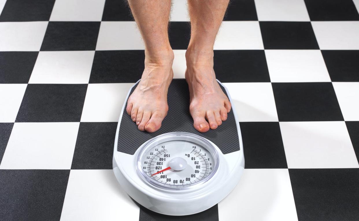<span class="caption">Patients with overweight or obesity issues make up more than 70% of the U.S. population.</span> <span class="attribution"><a class="link " href="https://www.gettyimages.com/detail/photo/overweight-man-standing-on-bathroom-scales-royalty-free-image/1169212311?adppopup=true" rel="nofollow noopener" target="_blank" data-ylk="slk:Peter Dazeley via Getty Images;elm:context_link;itc:0;sec:content-canvas">Peter Dazeley via Getty Images</a></span>