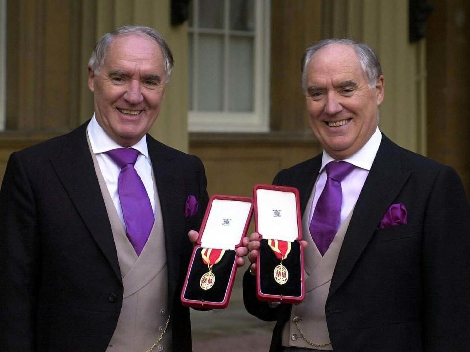 Sir David Barclay (left) and twin brother Sir Frederick after receiving knighthoods in 2000: PA