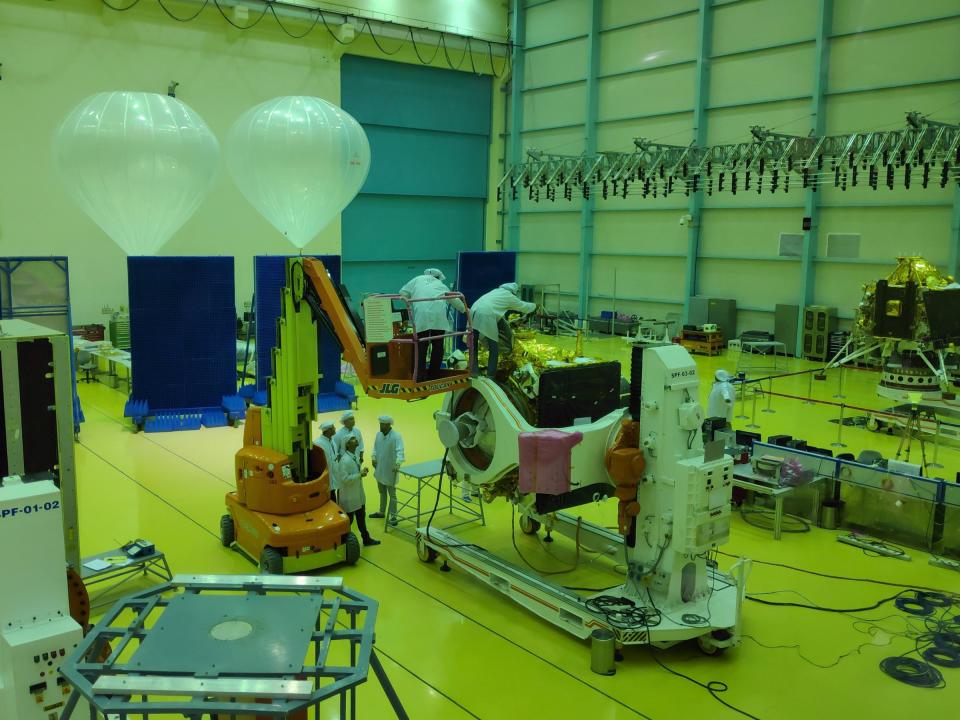 FILE PHOTO: Indian Space Research Organization (ISRO) scientists work on various modules of lunar mission Chandrayaan-2 at ISRO Satellite Integration and Test Establishment (ISITE) in Bengaluru, India, June 12, 2019. Picture taken through a green glass window. REUTERS/Chris Thomas/File Photo