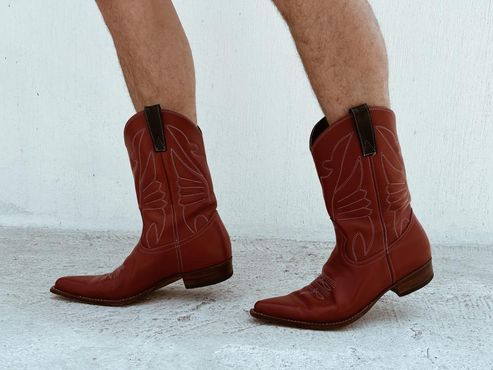Christian Grotewold feet wearing red cowboy boots