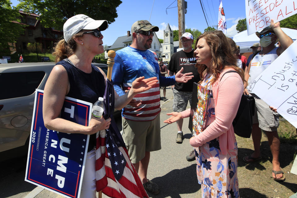 Supporters of President Donald Trump, left and center, argue with a protester prior to the arrival of the president, Friday, June 5, 2020, in Guilford, Maine. Trump is scheduled to visit Puritan Medical Products Co., one of the top two makers of testing swabs in the world. (AP Photo/Robert F. Bukaty)