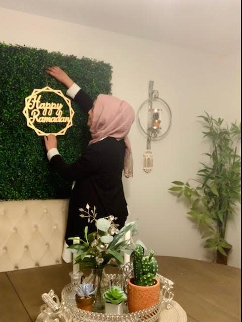 Maryland Director of CAIR Zainab Chaudry puts up decorations at home for Ramadan in Baltimore, Maryland.