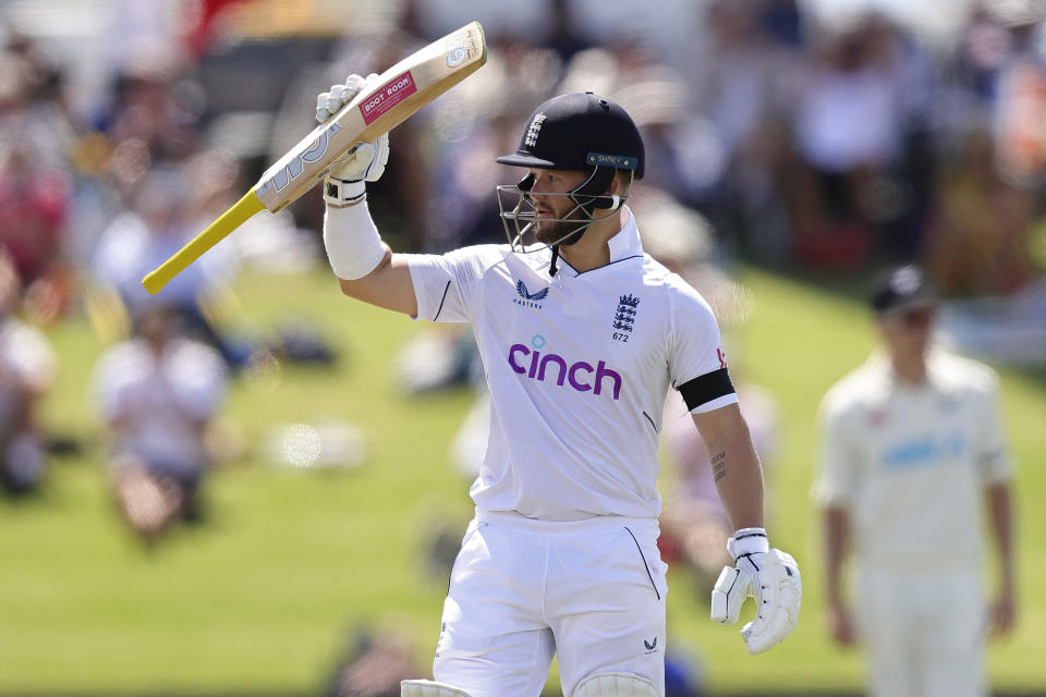 England's Ben Duckett raises his bat after making 50 runs against New Zealand on the first day of their cricket test match in Tauranga, New Zealand, Thursday, Feb. 16, 2023. (Aaron Gillions/Photosport via AP)