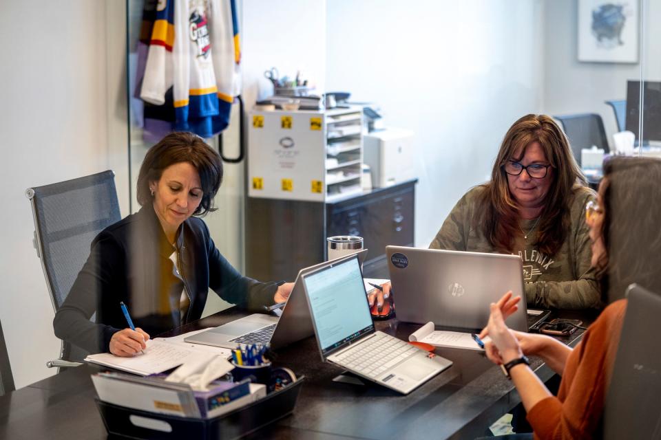 (Left to right) New Day Foundation co-founder and president Gina Kell Spehn talks with program director Cheryl Warstler and program specialist Jenny Moeller during a weekly cancer family support planning meeting at their office in Rochester Hills on Tuesday, March 23, 2023.