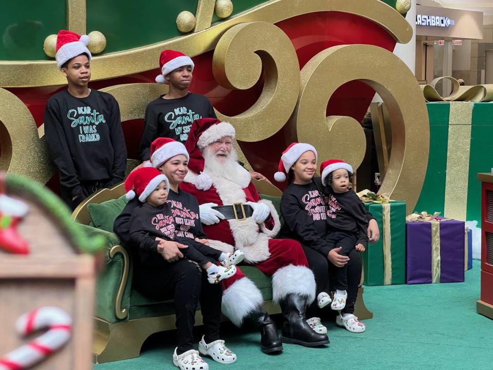 Cary resident Brittany Hester, 35, with her five children, poses with Santa at Crabtree Valley Mall this week.