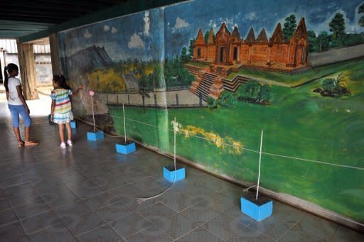 This photo, taken on May 13, shows young visitors looking at a painting inside the former Khmer Rouge commander Ta Mok's house at Anlong Veng district in Oddar Mean Chey province, some 400 km northwest of Phnom Penh. Anlong Veng, near the Thai border, was the Khmer Rouge's last rebel centre before the movement disintegrated in the late 1990s