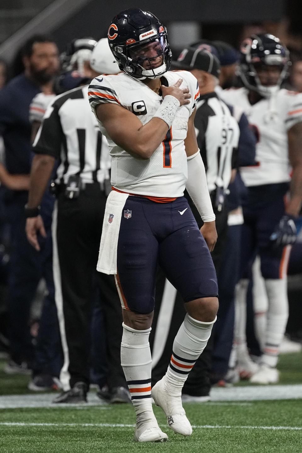 Chicago Bears quarterback Justin Fields (1) holds his shoulder after a Atlanta Falcons tackle during the second half of an NFL football game, Sunday, Nov. 20, 2022, in Atlanta. The Atlanta Falcons won 27-24. (AP Photo/John Bazemore)