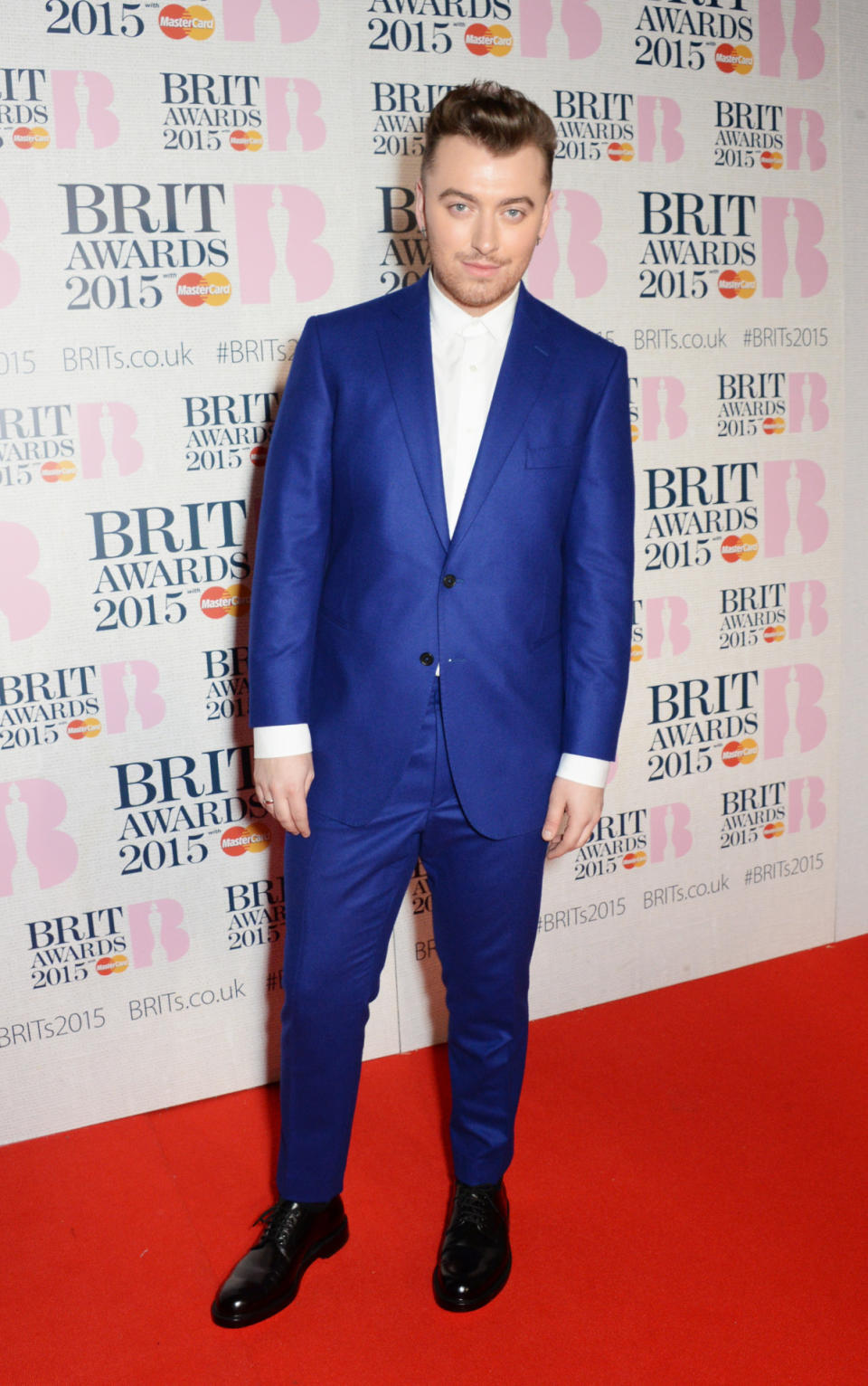 The breakout star stands out in a royal blue suit at the Brit Awards.