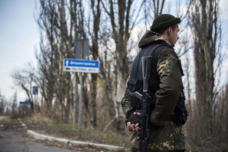 A pro-Russian soldier stands guard near the airport in Donetsk, on April 13, 2015