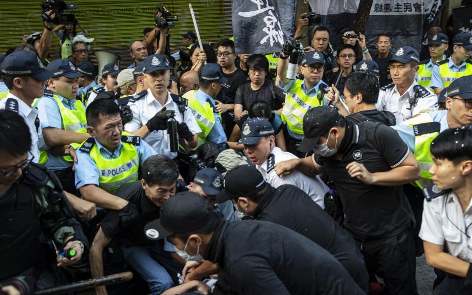 Police officers clash with demonstrators during a pro-democracy protest in the Wan Chai district of Hong Kong - Chan Long Hei /Bloomberg