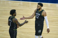 Minnesota Timberwolves center Karl-Anthony Towns (32) celebrates with Timberwolves guard Anthony Edwards (1) in the final minutes of their game against the Miami Heat during the second half of an NBA basketball game Friday, April 16, 2021, in Minneapolis. The Timberwolves won 119-111. (AP Photo/Craig Lassig)