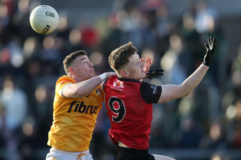 Antrim's Declan Lynch tackles Odhran Murdock of Down during the Ulster SFC quarter-final in April