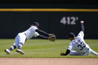 Detroit Tigers shortstop Zach McKinstry, left, and second baseman Colt Keith (33) reach for the single hit by Oakland Athletics' JJ Bleday during the fourth inning of a baseball game, Sunday, April 7, 2024, in Detroit. (AP Photo/Carlos Osorio)