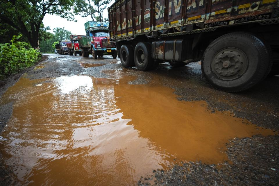 Trucks transport chromium ore near a mine at Kaliapani village in Jajpur district, Odisha, India on Thursday, July 6, 2023. Kaliapani is impoverished, has barely any access to clean water and residents claim their chronic overexposure to chromium has caused lasting health problems. (AP Photo/Anupam Nath)