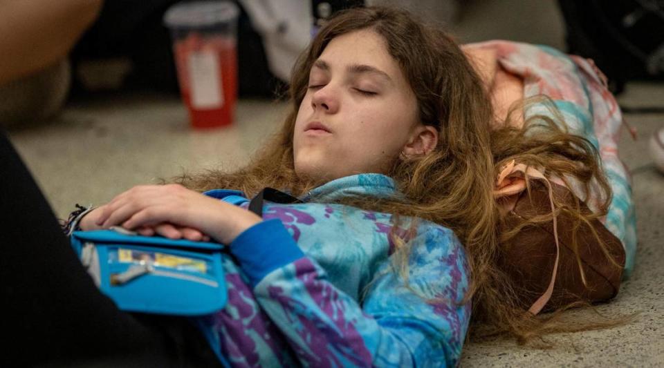 Miami, Florida - June 20, 2023 - Student Michelle McMullen takes a nap while she and her fellow students wait for a flight to Costa Rica. A group of Middle school students from Reno, Nevada missed their connection to Costa Rica last night after their flight to Miami was diverted to Tampa due to thunderstorms. Jose A. Iglesias/jiglesias@elnuevoherald.com