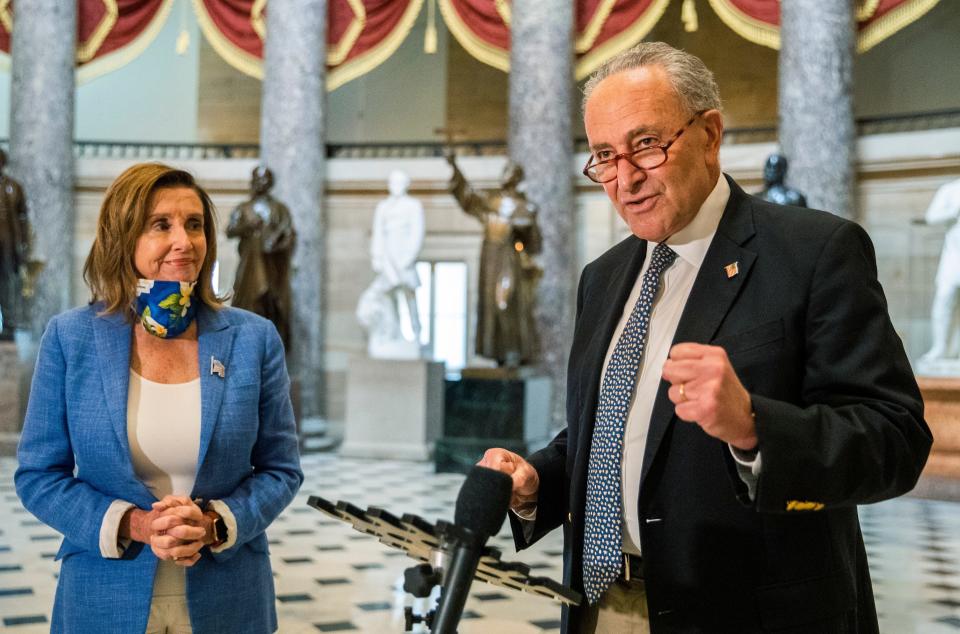 Senate Minority Leader Chuck Schumer of N.Y., with House Speaker Nancy Pelosi of Calif., speaks to reporters following a meeting at the Capitol with White House chief of staff Mark Meadows and Treasury Secretary Steven Mnuchin on Saturday.