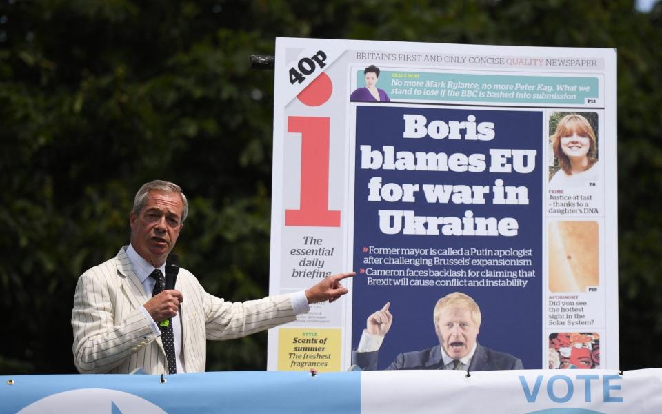 Nigel Farage, the Reform leader, unveils a giant copy of an "i" newspaper frontpage during a campaign event in Maidstone