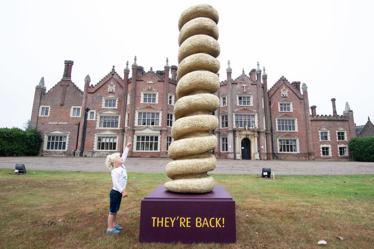 Reign Thornton (age 3), from Gorleston, views a 3m high statue of a Turkey Twizzler that is unveiled at Bernard Matthews' Great Witchingham Hall in Norwich, Norfolk as it makes a comeback after 15 years – now with two flavours, it's healthier and tastier than before: PA
