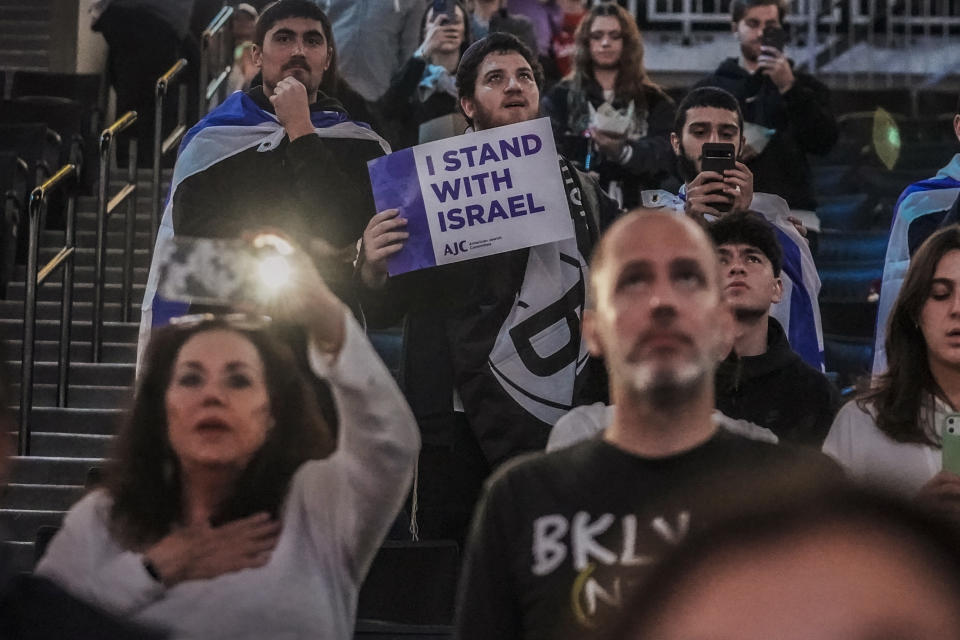 Fans show support for Israel as they stand during the national anthem before a preseason NBA basketball game between Israel's Maccabi Ra'anana the Brooklyn Nets, Thursday, Oct. 12, 2023, in New York. (AP Photo/Bebeto Matthews)