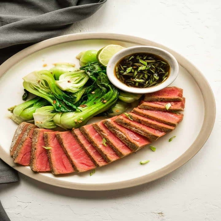 Sliced tuna steak with bok choy.