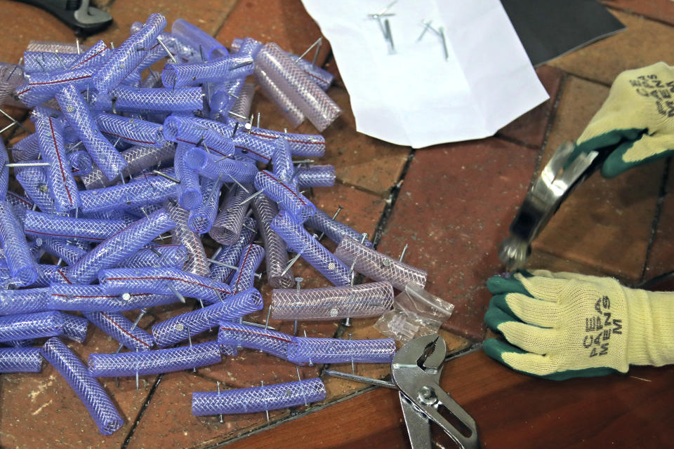 In this Thursday, Nov. 14, 2019, file photo, a pro-democracy protester makes nail roadblocks inside the campus of the University of Hong Kong, early Thursday, Nov. 14, 2019. Protesters who barricaded themselves inside Hong Kong’s universities have tried to turn the campuses into armed camps, resorting to medieval weapons to stop police from entering the grounds. Their weapons include bows and arrows, catapults and hundreds of gasoline bombs stacked up to ramparts - often built by the students. (AP Photo/Kin Cheung, File)