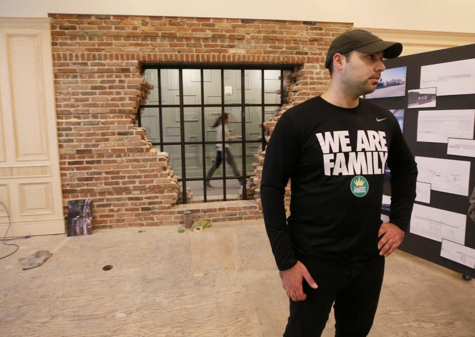 Nicholas Lopez, creative director for the LeBron James Family Foundation, talks about a planned lounge area near a coffee shop in House Three Thirty in Akron.