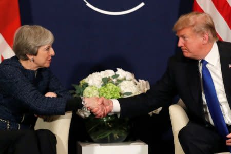 FILE PHOTO - U.S. President Donald Trump shake hands with Britain's Prime Minister Theresa May during the World Economic Forum (WEF) annual meeting in Davos, Switzerland January 25, 2018 REUTERS/Carlos Barria