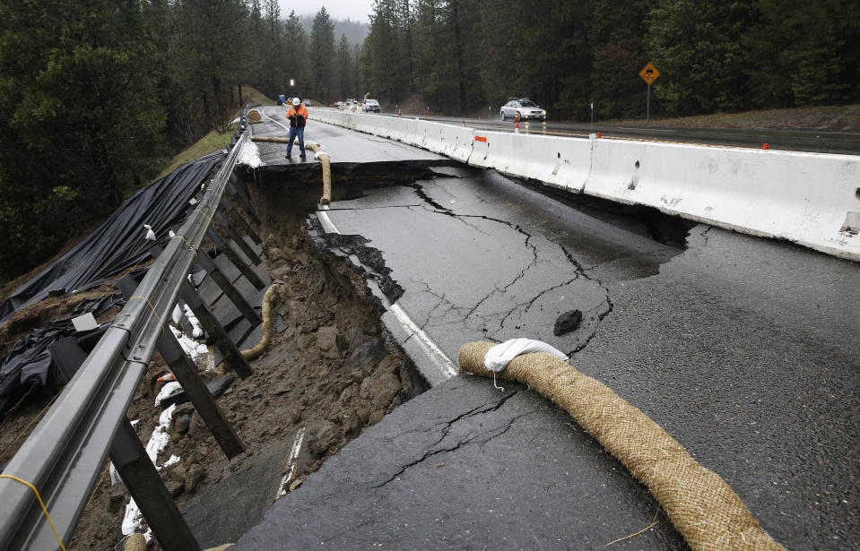 FILE - In this Feb. 21, 2017, file photo, the shoulder and one lane of westbound Highway 50 are damaged due to storms near Pollock Pines, Calif. The bill to repair California's roadways hammered by floods and rockslides in an onslaught of storms this winter is already at least $550 million, more than double what the state budgeted for such emergencies. State lawmakers are nearing a vote on a plan to raise taxes and fees for road construction, barely a week after Gov. Jerry Brown and top legislative leaders revealed their negotiated agreement and began rushing it through the Legislature. (AP Photo/Rich Pedroncelli, File)