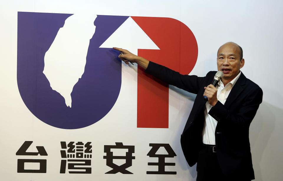 Han Kuo-yu of the Nationalist Party shows his campaign logo with a slogan "Taiwan Safety" during a press event in Taipei, Taiwan, Thursday, Nov. 14, 2019. The China-friendly opposition candidate in Taiwan’s upcoming presidential election is urging Hong Kong to adopt universal suffrage as the best way of stemming months of anti-government protests. (AP Photo/Chiang Ying-ying)