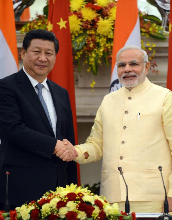Chinese President Xi Jinping (left) agreed several trade deals with Indian Prime Minister Narendra Modi during a 2014 visit to New Delhi