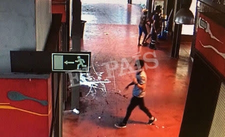 A watermarked CCTV frame grab provided by Spanish newspaper El Pais shows a suspect walking through La Boqueria market seconds after a van crashed into pedestrians in Barcelona, Spain, August 17, 2017. Courtesy of El Pais via REUTERS