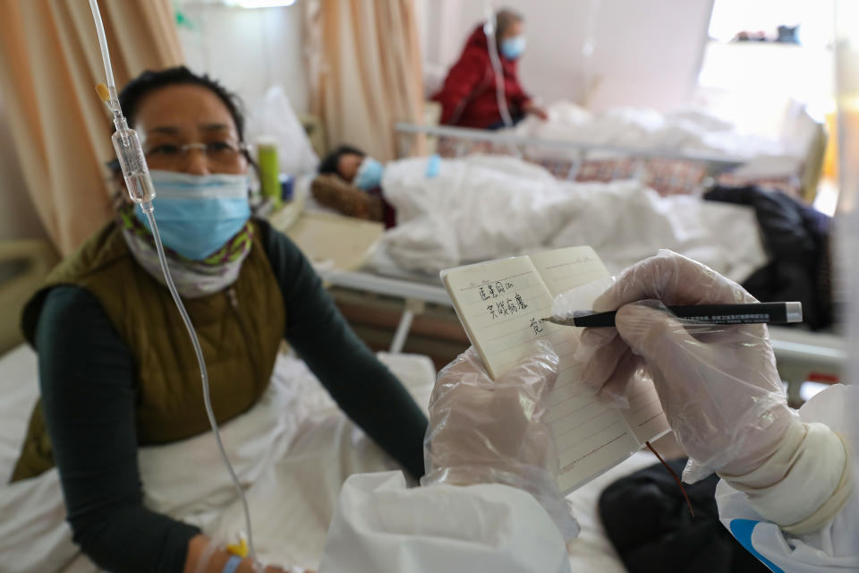 WUHAN, CHINA - FEBRUARY 25 2020: Dr. Fan Zhongjie, a respiratory specialist in charge of about 30 critical COVID-19 patients in his section, writes encouraging words for a patient in a hospital in Wuhan in central China's Hubei province Tuesday, Feb. 25, 2020. After the hospital was designated for COVID-19 patients and doctors and nurses of other disciplines were all assigned to respiratory patients, he has also to oversee his colleagues' jobs and help them.- PHOTOGRAPH BY Feature China / Barcroft Studios / Future Publishing (Photo credit should read Feature China/Barcroft Media via Getty Images)