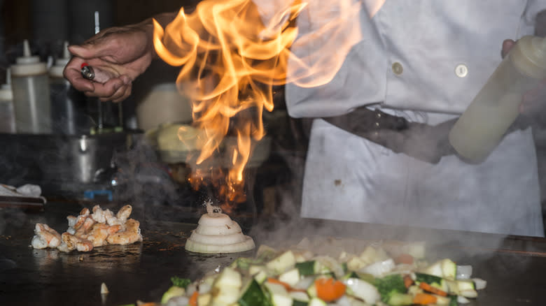 Chef lighting an onion volcano