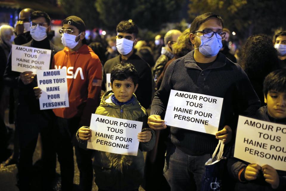 <span class="caption">At a memorial march for slain teacher Samuel Paty – an act that prompted school reform proposals – people hold placards stating ‘Love for all, hate for no one’.</span> <span class="attribution"><a class="link " href="https://newsroom.ap.org/detail/FranceTeacherDecapitated/f263f455fe1a4a00b0ec0b1713b0e05e/photo?Query=Samuel%20Paty,&mediaType=photo&sortBy=arrivaldatetime:desc&dateRange=Anytime&totalCount=89&currentItemNo=46" rel="nofollow noopener" target="_blank" data-ylk="slk:AP Photo/Lewis Joly;elm:context_link;itc:0;sec:content-canvas">AP Photo/Lewis Joly</a></span>