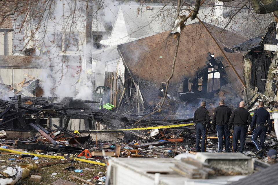 Police officers stand at the scene of a deadly explosion that leveled a home in Omaha, Neb., Tuesday, Dec. 8, 2020. (AP Photo/Nati Harnik)