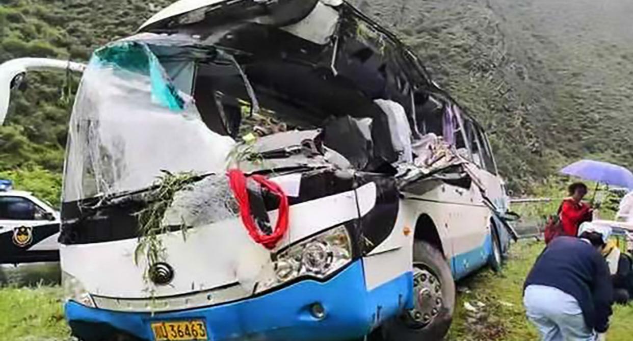 The tourist bus which crashed off road after being violently struck by a 1-tonne boulder (ASIA WIRE)