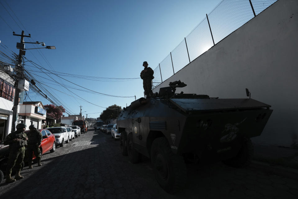 Soldiers stand guard outside the El Inca prison, as election materials arrive for detainees who are not convicted but whose cases are in process, for early voting in the presidential election in Quito, Ecuador, Thursday, Aug. 17, 2023. Ecuadorians will choose a new president on Aug. 20. (AP Photo/Dolores Ochoa)