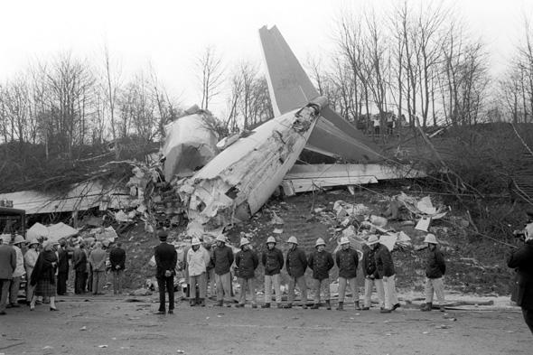 File photo dated 09/01/1989 of emergency services workers standing in front of wreckage at the scene after a Belfast-bound British Midland Boeing 737 crashed on an embankment of the M1 at Kegworth. Villagers are marking the 25th anniversary of the Kegworth air disaster today - a tragedy that spread grief from Leicestershire all the way to Belfast.